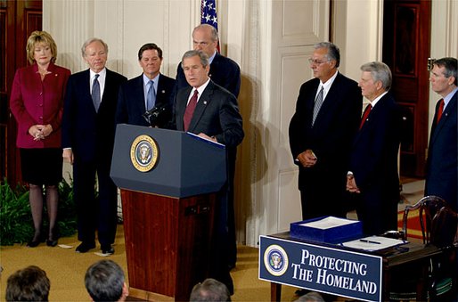 President George W. Bush at a podium during the Homeland Security Act signing in the East Room.